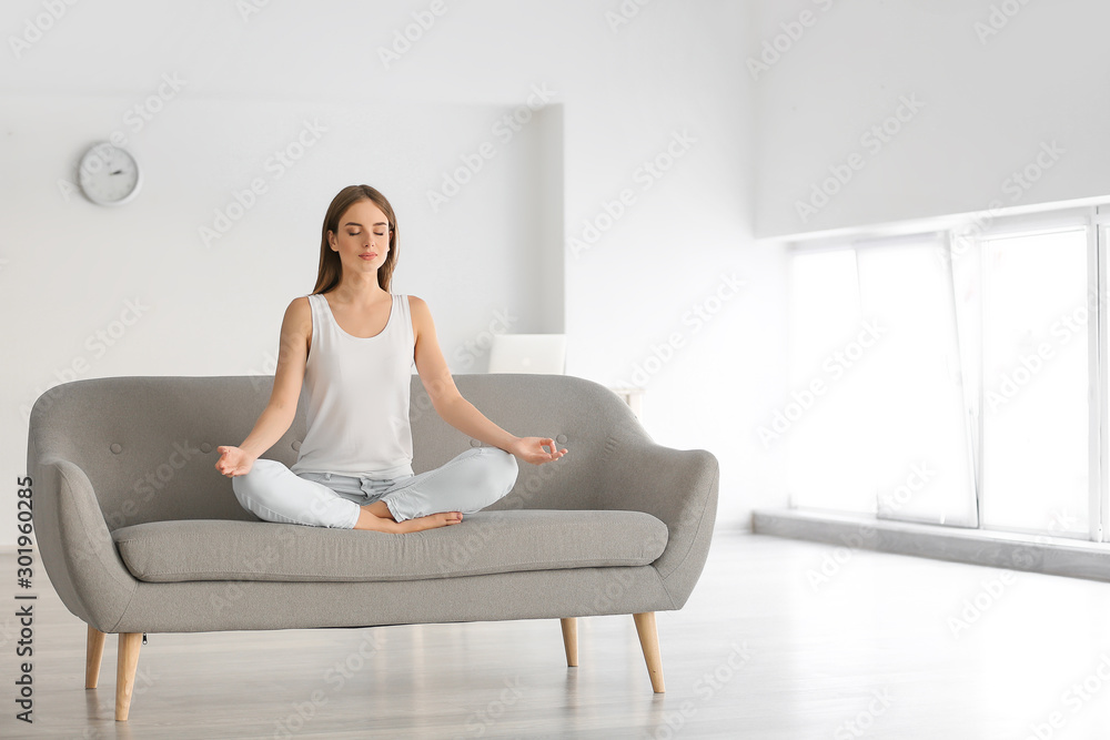 Young woman practicing yoga at home Young woman practicing yoga at home