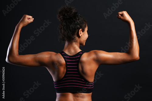 Sporty African-American woman on dark background