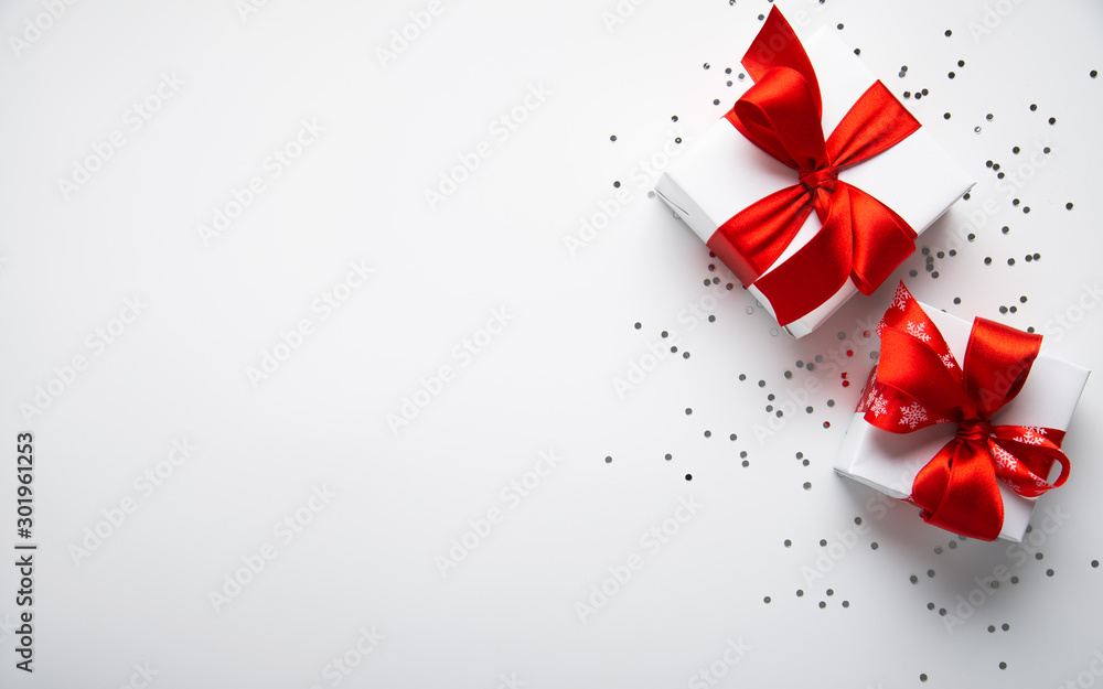 White gifts with red ribbon, present on white background top view. Merry Christmas and Happy Holidays. New Year. Valentine's day. Birthday. - obrazy, fototapety, plakaty 