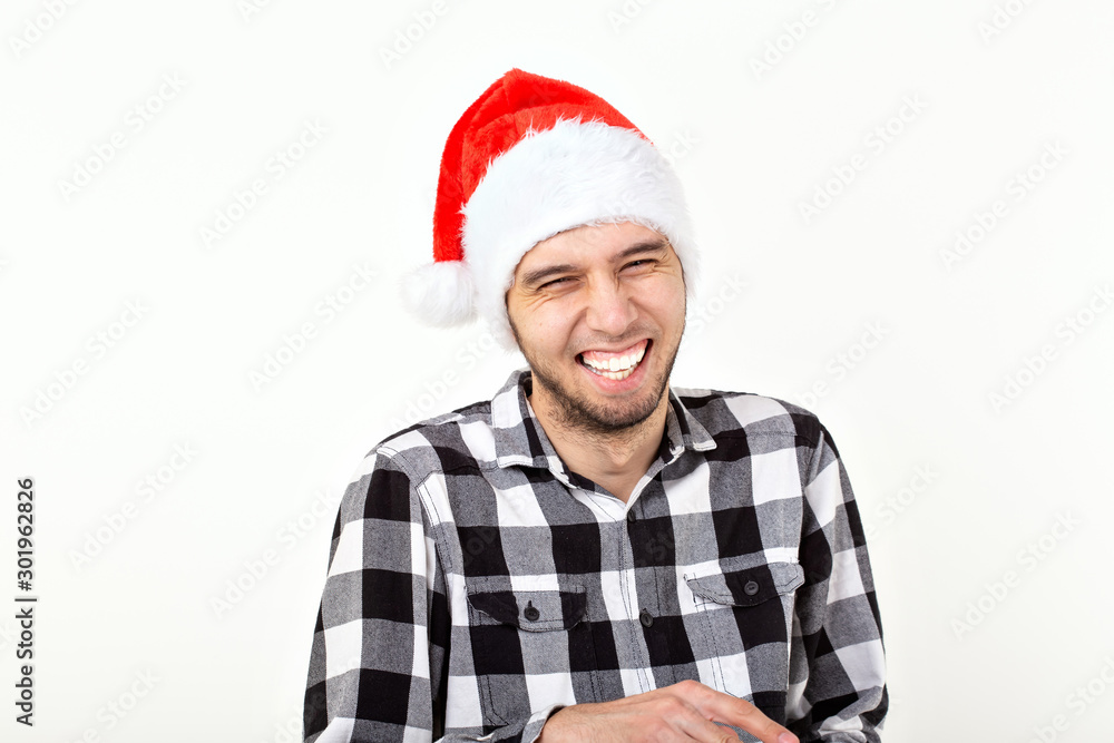 X-mas, winter holidays and people concept - funny emotional man in santa claus hat over white background X-mas, winter holidays and people concept - funny emotional man in santa claus hat over white background
