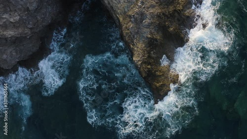 Flying Above Waves Crashing of Rocks. Aerial view of Turquoise Waves in the sea 