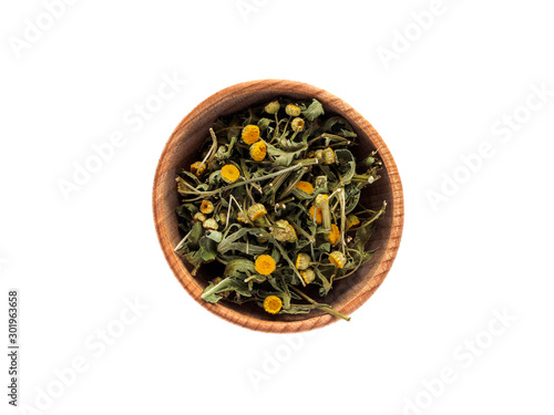 Dry Tanacetum or tansy flowers in a wooden Cup on a white background