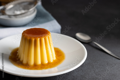 Homemade creme caramel desert on a dark background