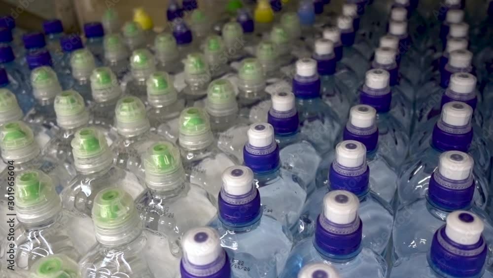 Plastic water bottles, caps. Camera in motion, top view Plastic water bottles, caps. Camera in motion, top view