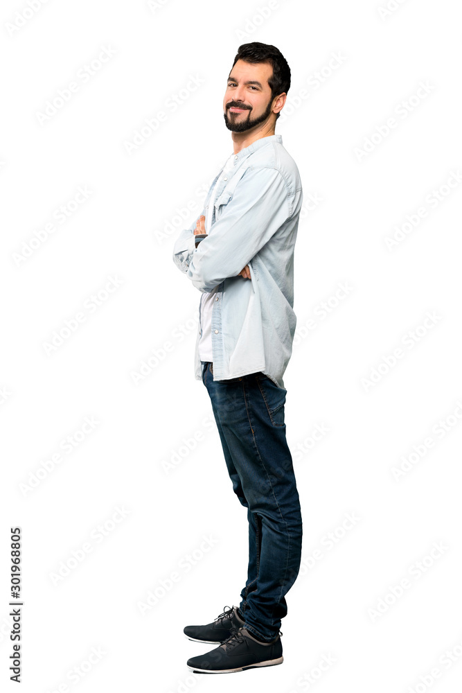 Fototapeta premium Full-length shot of Handsome man with beard with arms crossed and looking forward over isolated white background