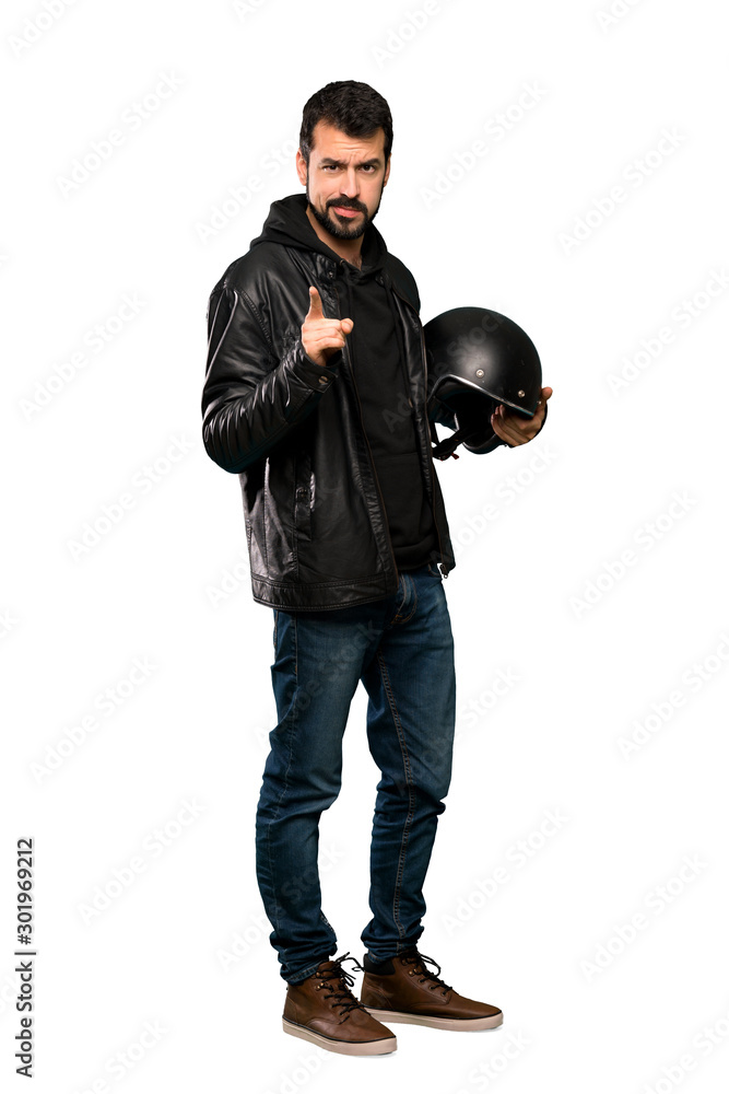 Full-length shot of Biker man frustrated and pointing to the front over isolated white background Full-length shot of Biker man frustrated and pointing to the front over isolated white background