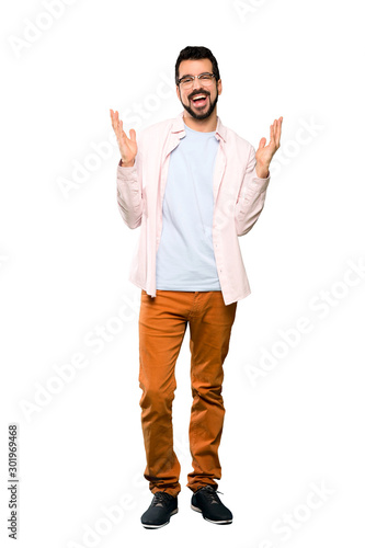 Full-length shot of Handsome man with beard smiling a lot over isolated white background © luismolinero