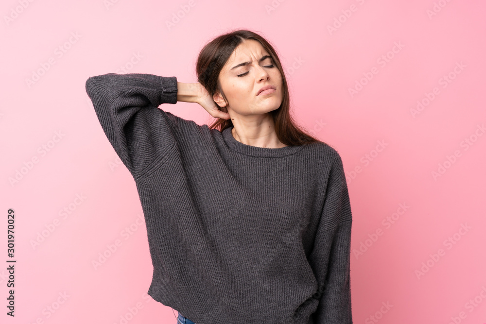 Young woman over isolated pink background with neckache Young woman over isolated pink background with neckache