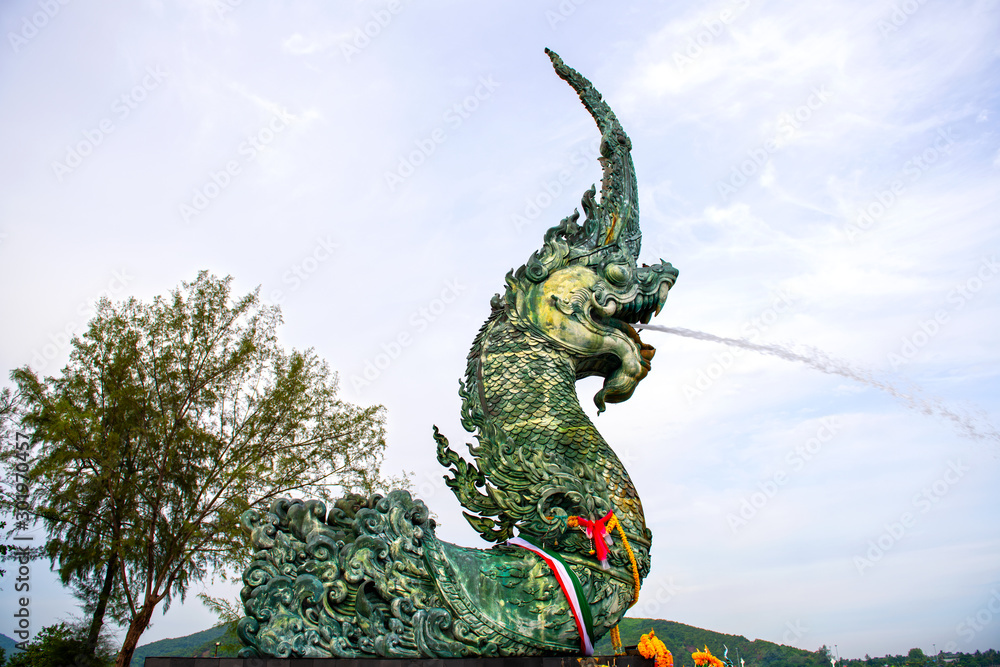 Naga sculptures spraying water A symbol of Songkhla Province, Thailand The floating Spraying water into the estuary lake is popular with tourists,Take pictures Songkhla Province,Thailand Jun 19, 2015