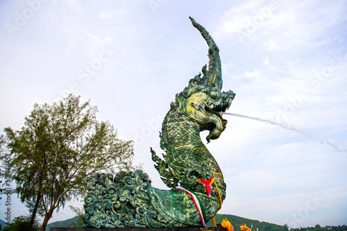 Naga sculptures spraying water A symbol of Songkhla Province, Thailand The floating Spraying water into the estuary lake is popular with tourists,Take pictures Songkhla Province,Thailand Jun 19, 2015 © pcbang