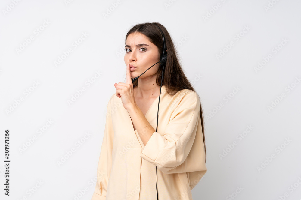 Young telemarketer woman over isolated white background doing silence gesture Young telemarketer woman over isolated white background doing silence gesture
