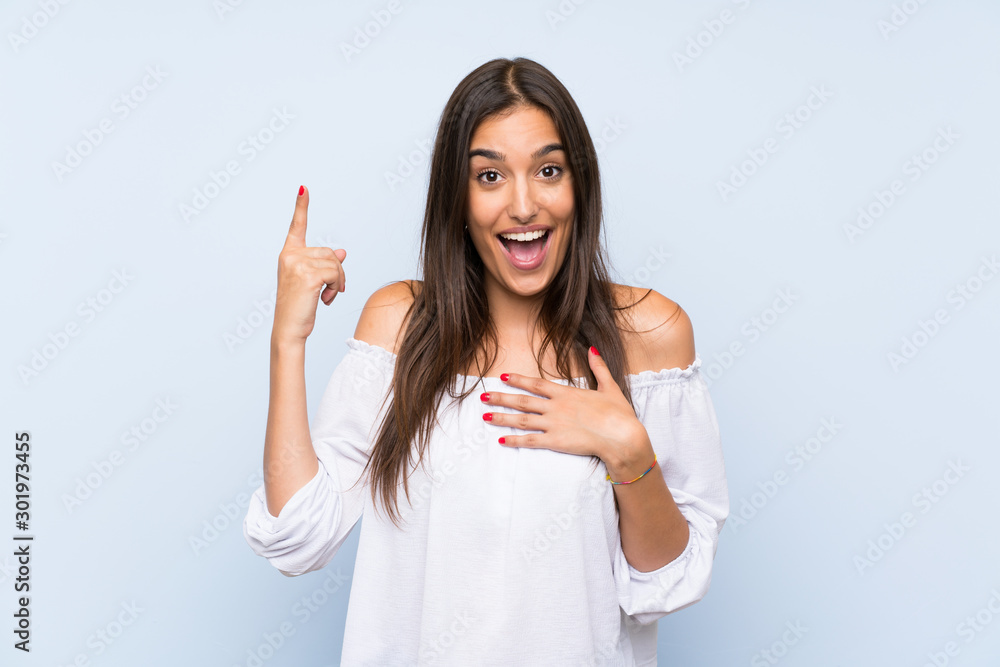 Young woman over isolated blue background with surprise facial expression Young woman over isolated blue background with surprise facial expression