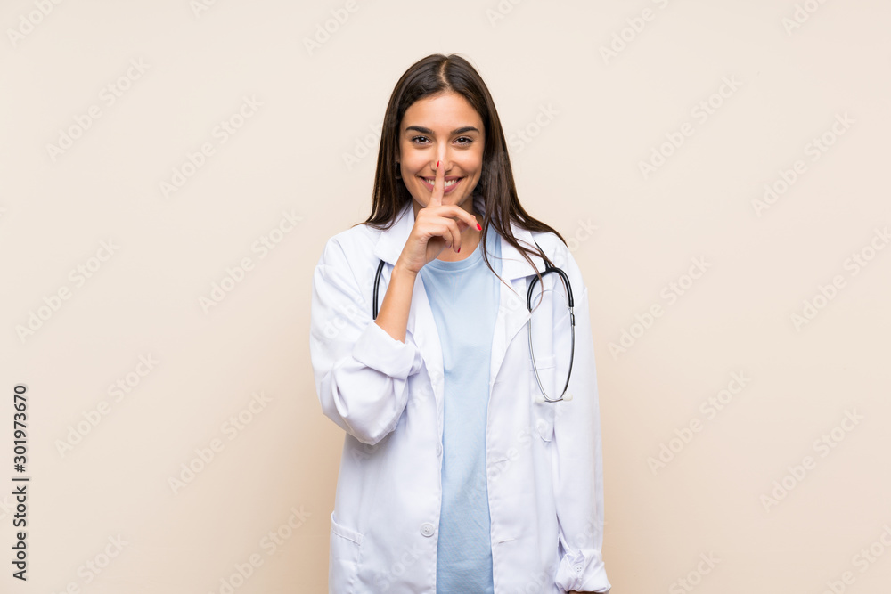 Young doctor woman over isolated background doing silence gesture Young doctor woman over isolated background doing silence gesture