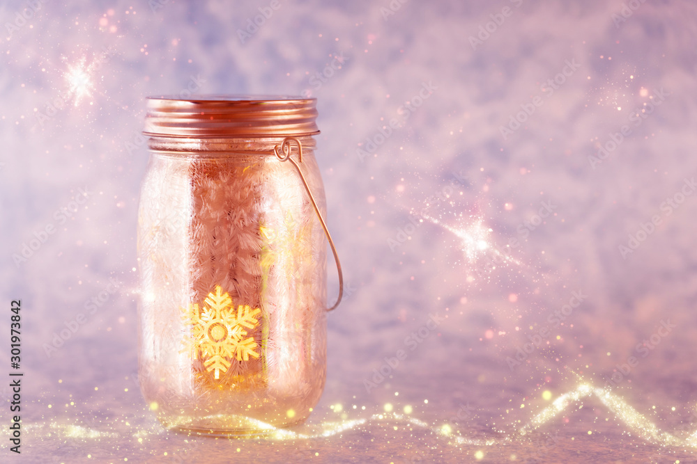 Christmas decoration with a golden shimmering glass with a shining snowflake, copy space Christmas decoration with a golden shimmering glass with a shining snowflake, copy space