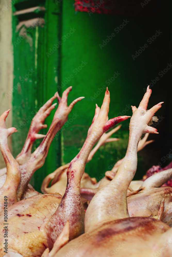 Chicken with legs  on street market, green background