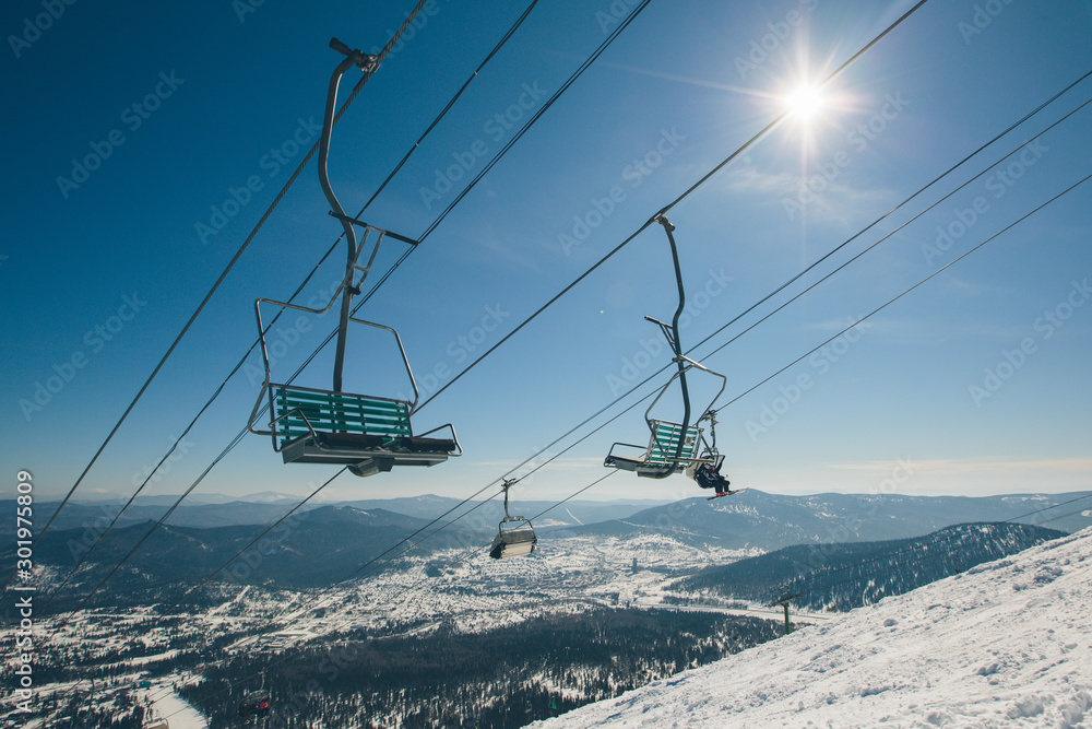 Ski lift on the slop in mountain ski resort Ski lift on the slop in mountain ski resort