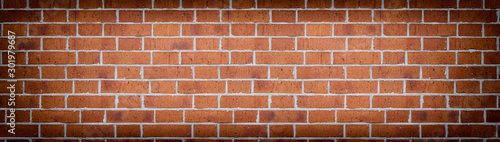 Wide red brick wall texture. Rough orange brickwork widescreen backdrop. Large long abstract background