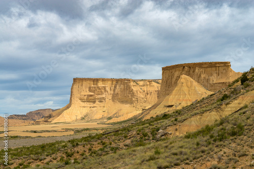 Flat-topped mountains with steep escarpments above a plain in the Spanish desert Bardenas Reales photo