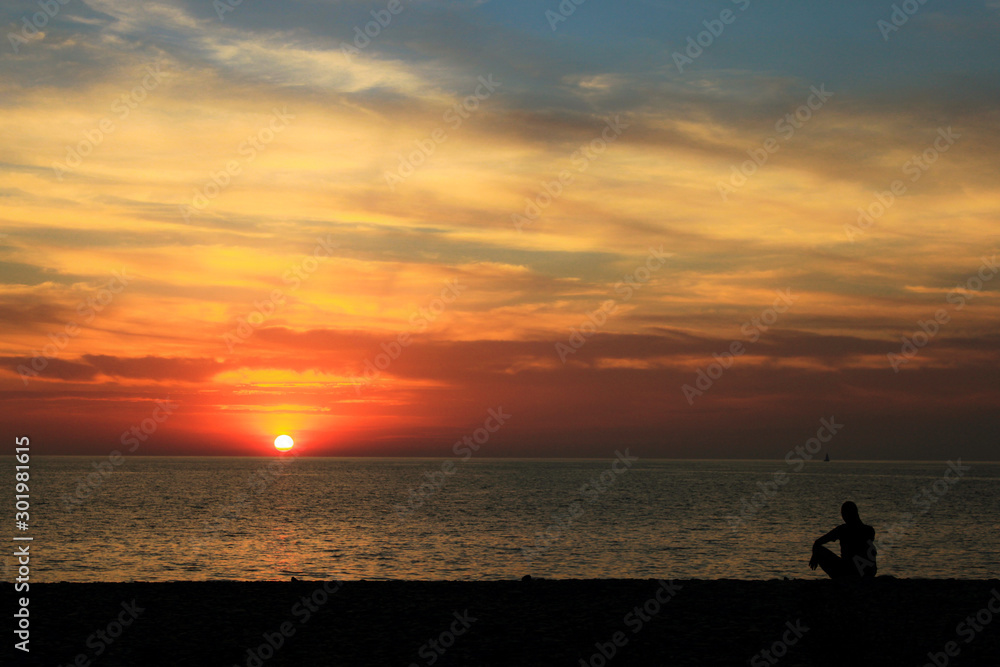 silhouette of man on beach at sunset silhouette of man on beach at sunset
