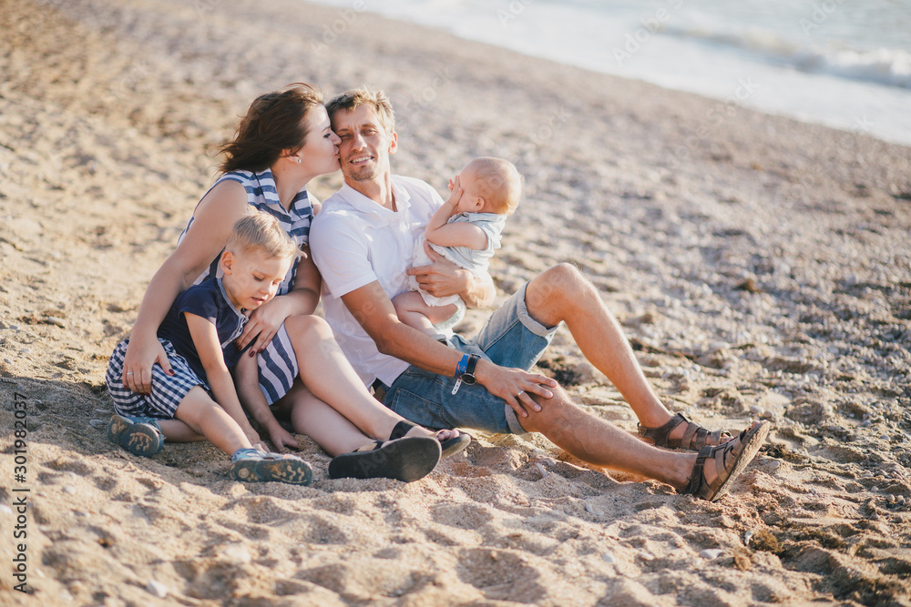 Happy family having fun near sea at the beach. Happy family having fun near sea at the beach.