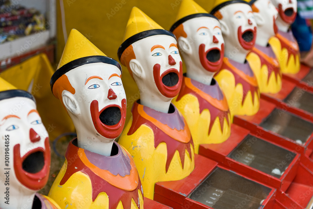 Brightly colored sideshow clowns at a circus.. Brightly colored sideshow clowns at a circus..