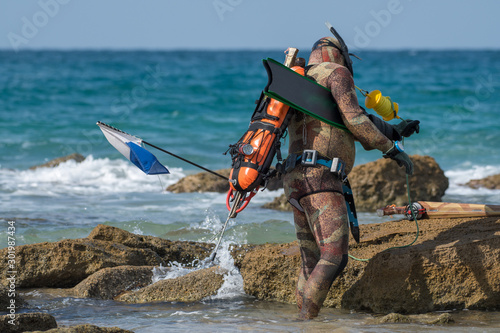 Isolated close up of a single spear fisherman getting ready to enter the sea- Israel