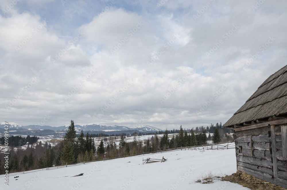 old decrepit wooden building in snow-covered mountains. old decrepit wooden building in snow-covered mountains.