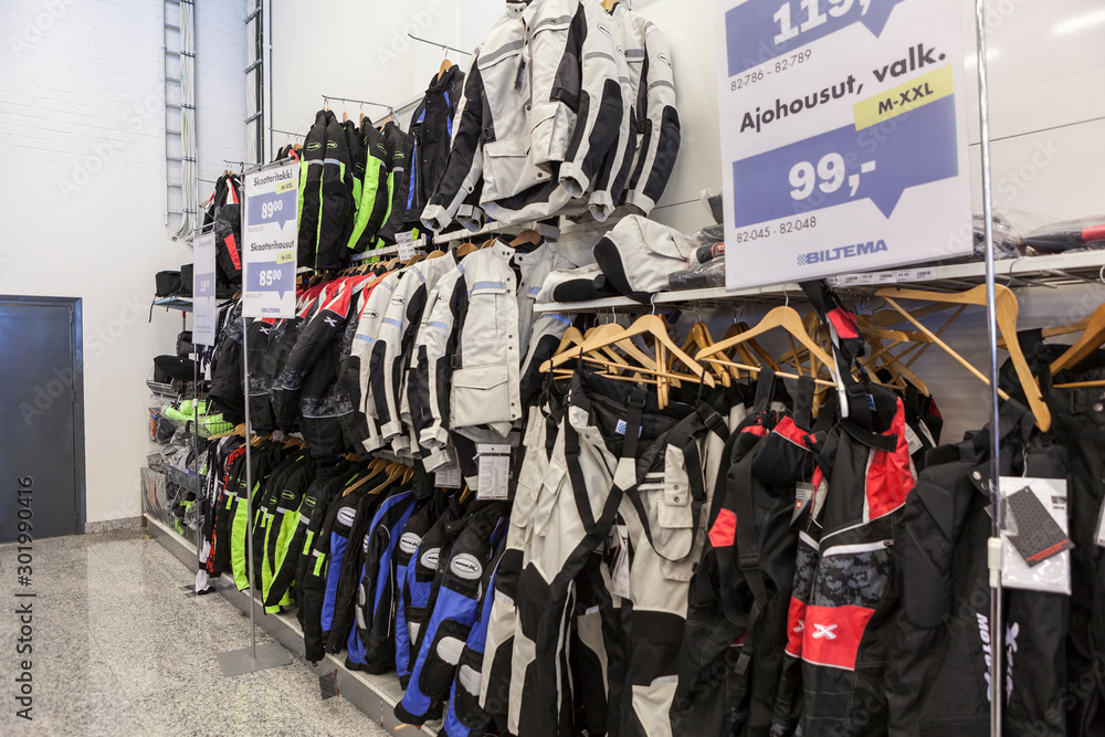 Textile motorcycle jackets and pants are in salesroom of wholesale  hypermarket. Biltema is is a Swedish chain of retail stores in Nordic  countries Stock Photo | Adobe Stock