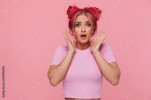 Portrait of shocked young woman with colorful hairstyle screaming in fear