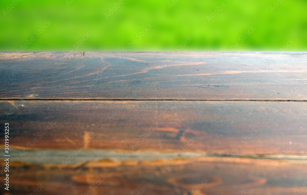 Empty wood table top on blur abstract green from garden in morning background. can be used for display or montage your products Empty wood table top on blur abstract green from garden in morning background. can be used for display or montage your products