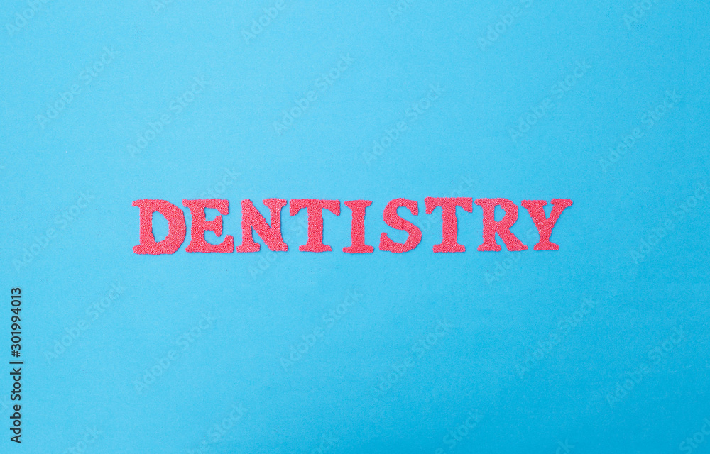 The word dentistry on a blue background. Concept sections of medicine dealing with dental treatment and problems.