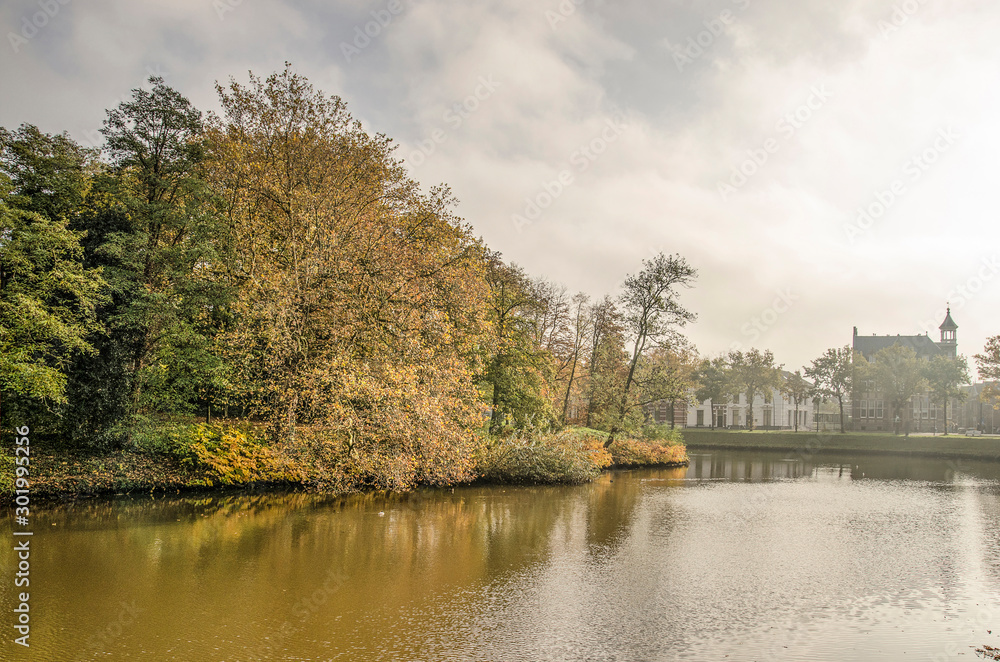 Zwolle, the Netherlands, November 11, 2019: view across the town's ramparts canal towards the adjacent park on a somewhat misty day in autumn