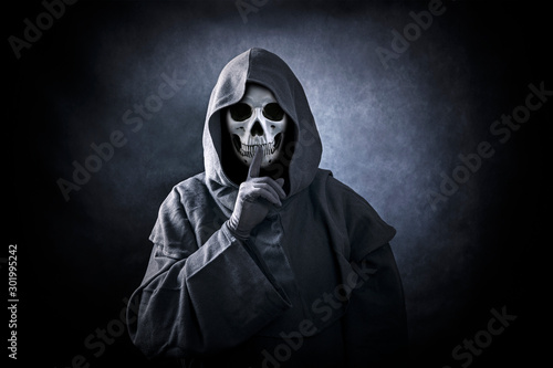 Grim reaper showing hush sign photo
