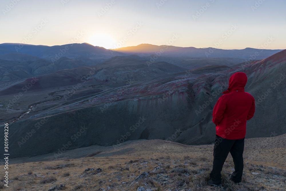 Azerbaijan, Xizi - November 8, 2019: Hiker watching the sunset in the mountains