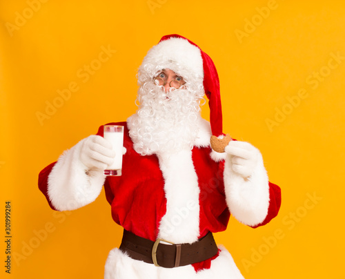 Santa Claus with glass of milk and ginger biscuit photo