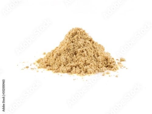 Small heap of ground mustard isolated on white background with copy space for text, images. Spices and herbs. Packaging concept. Close-up, side view.