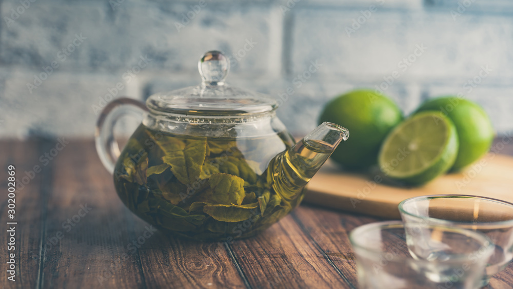 The tea leaves are brew in boiling water and infuse in a small teapot. The concept of the tea party. Green tea in a teapot