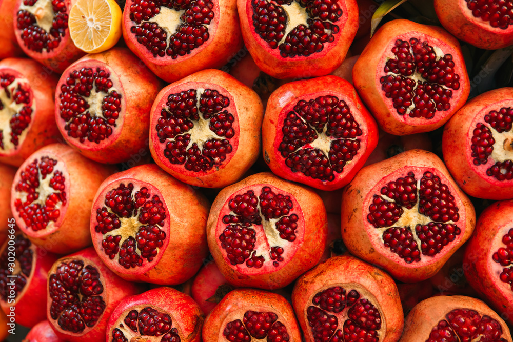 Photo of Grenades on the supermarket shelf. Pomegranates on the street market Photo of Grenades on the supermarket shelf. Pomegranates on the street market