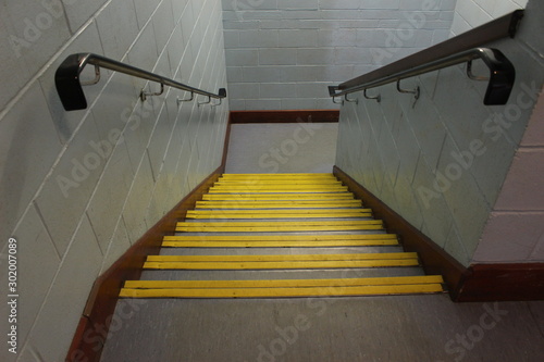 Photography Interior office school staircase stairway, stone steps with yellow edging down p
