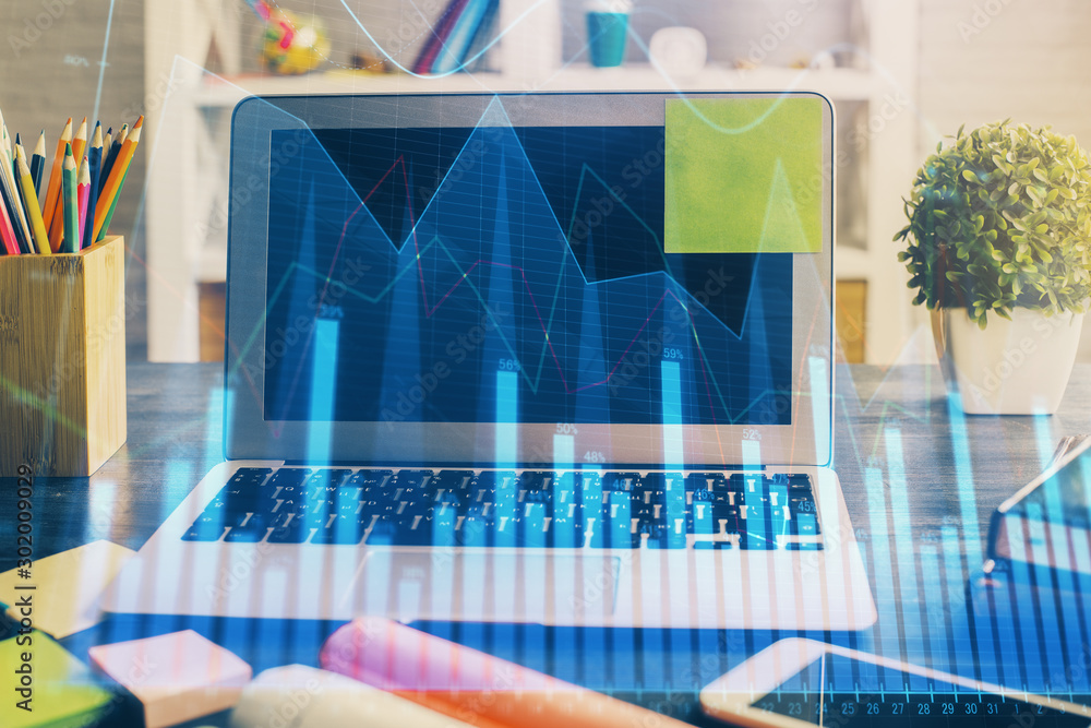 Financial graph colorful drawing and table with computer on background. Double exposure. Concept of international markets. Financial graph colorful drawing and table with computer on background. Double exposure. Concept of international markets.