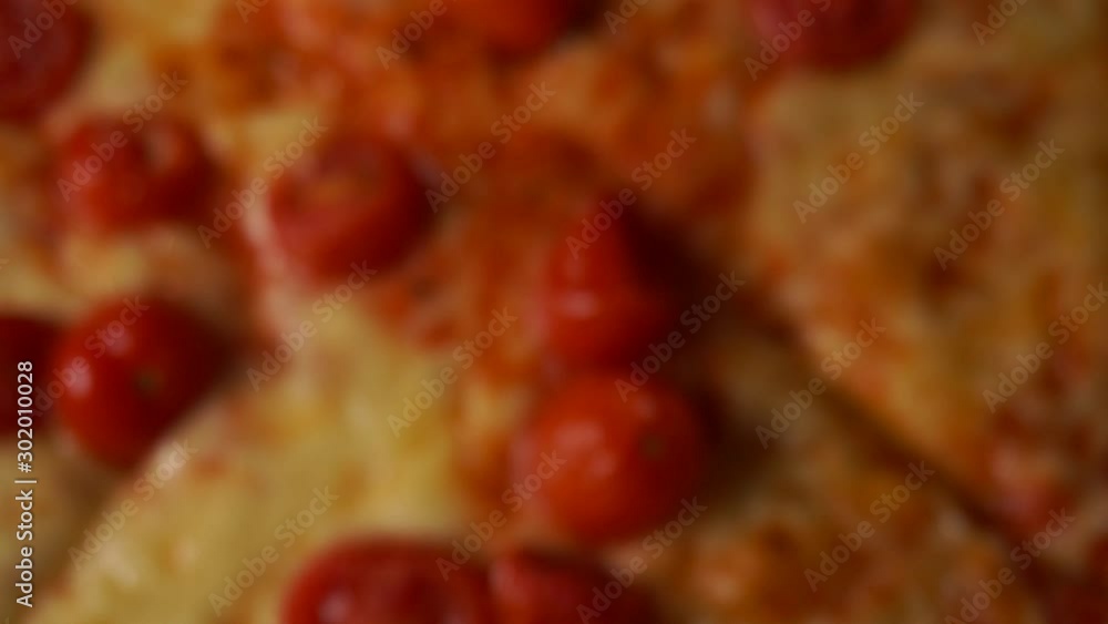 Slow motion ,homemade pizza with tomatoes ,slowly coming into focus Slow motion ,homemade pizza with tomatoes ,slowly coming into focus
