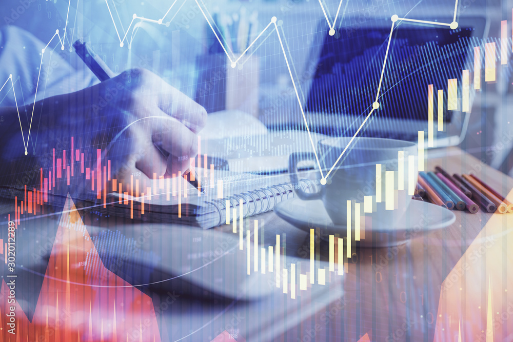 Financial chart drawn over hands taking notes background. Concept of research. Double exposure Financial chart drawn over hands taking notes background. Concept of research. Double exposure