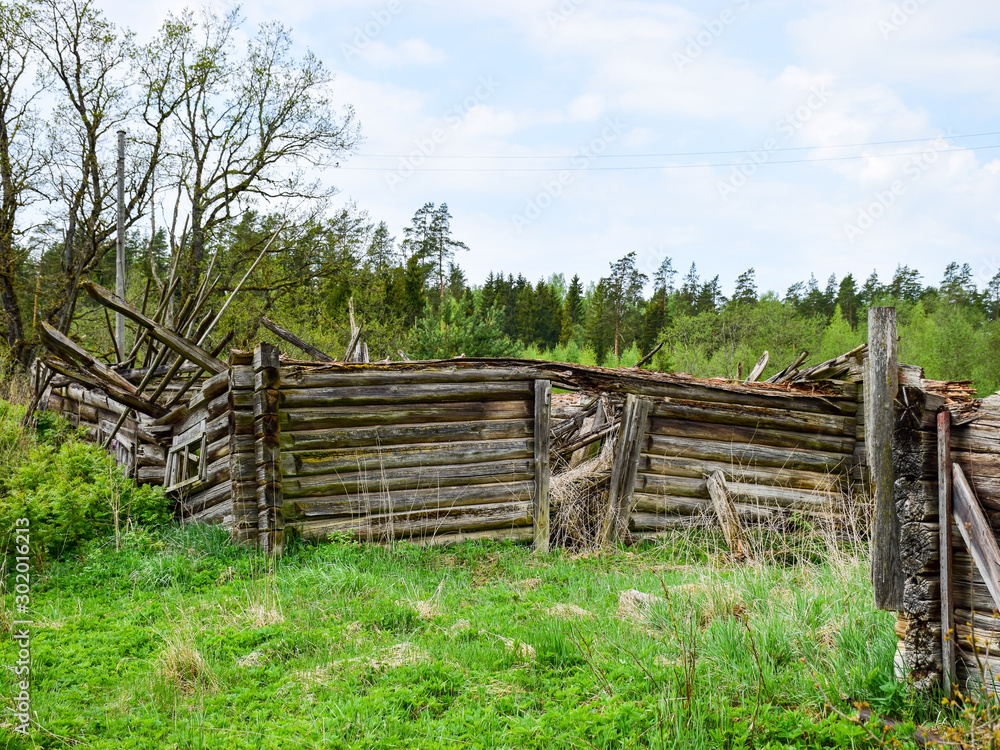 landscape with old and collapsed country house, collapsed wall and old wooden logs landscape with old and collapsed country house, collapsed wall and old wooden logs