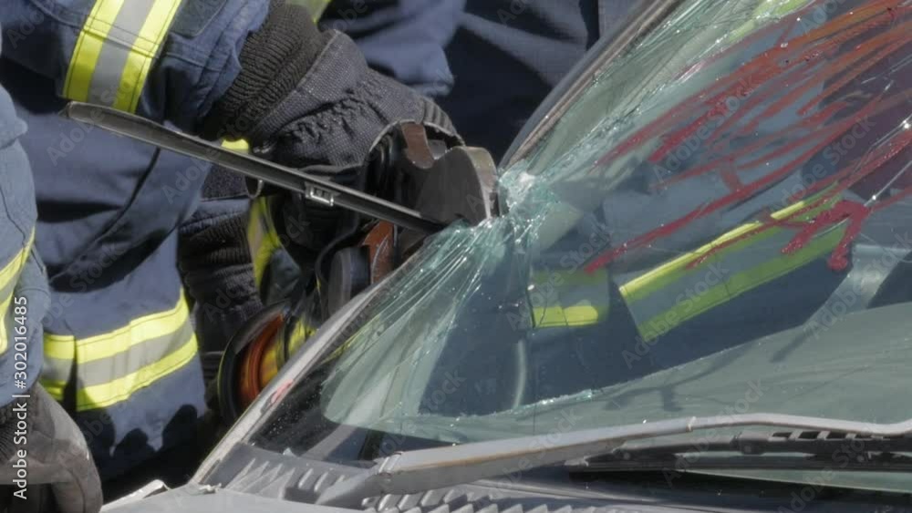 Firefighters work to rescue a man trapped inside a car after a traffic ...