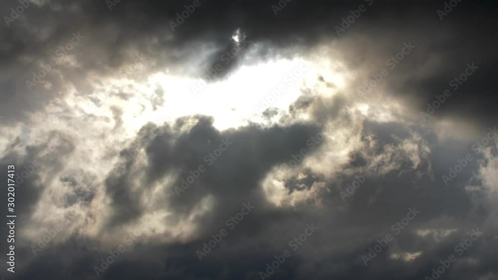 Sun breaks through dense storm clouds causing an epic scene of nature’s brilliance Sun breaks through dense storm clouds causing an epic scene of nature’s brilliance