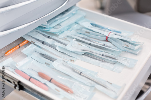 Close up of dentist tools in open drawer