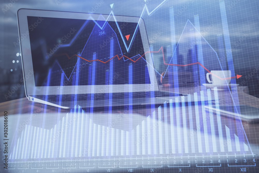 Financial market graph hologram and personal computer on background. Multi exposure. Concept of forex. Financial market graph hologram and personal computer on background. Multi exposure. Concept of forex.