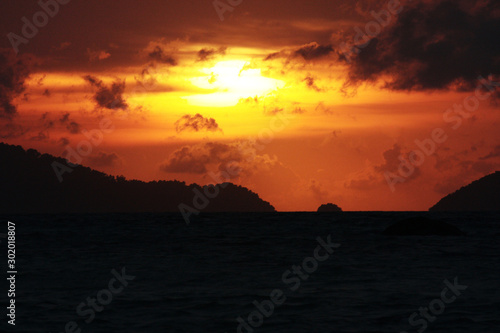 Beautiful seascape and tropical island with sky in twilight of sunset over the mountain in sea at Thailand