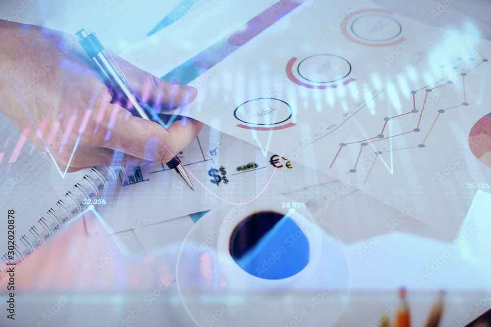 Multi exposure of man planing investment with stock market forex chart. Multi exposure of man planing investment with stock market forex chart.