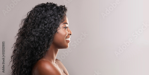 Smiling attractive woman with perfect skin and beautiful curly hair